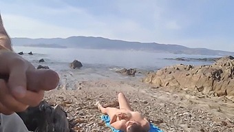 A Nude Milf Receives A Flash From An Exhibitionist On The Beach